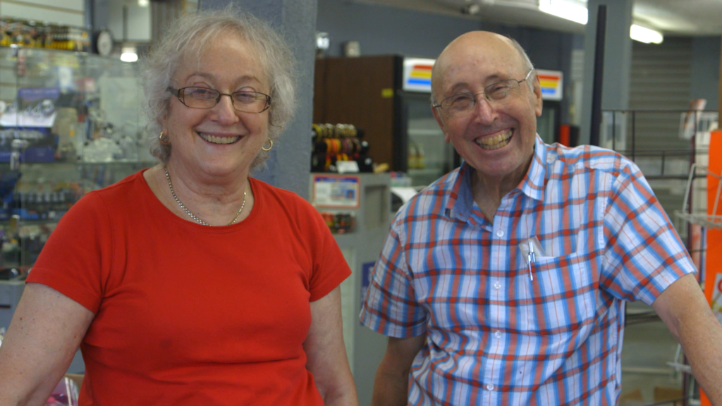 A photo of Karen and Barry Mason, subjects of Circus of Books, smiling directly into the camera.