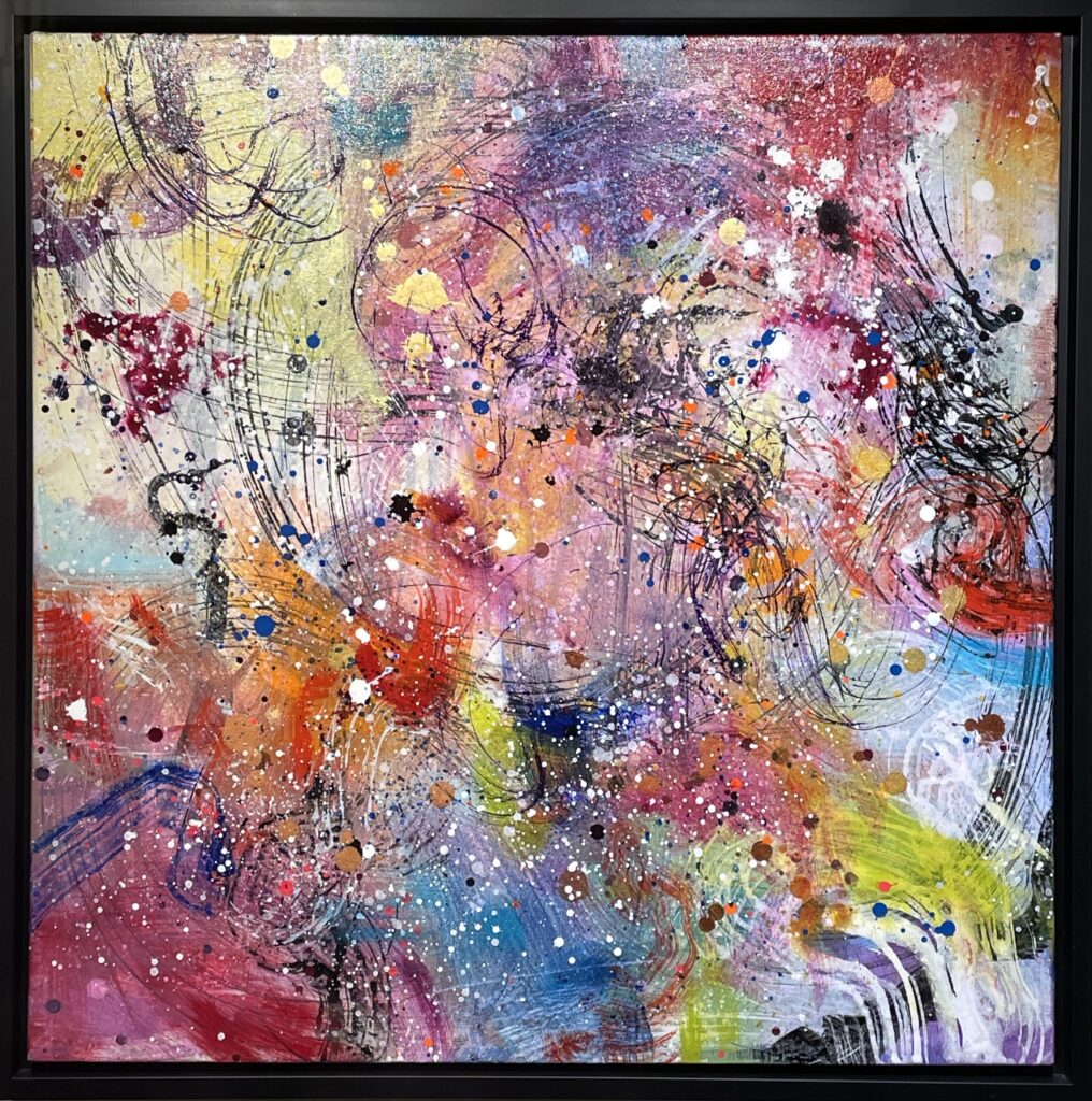 A photo of a painting by Skai Fowler. It is a brightly colourful abstract painting of patterned splotches.